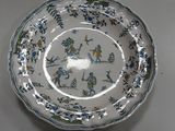 a white plate with blue and green designs on it