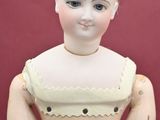 a wooden doll that is sitting on a table