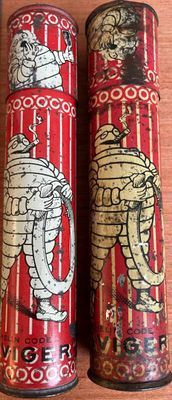 two tins with images of elephants on them sitting on a table
