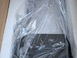 a box with a laptop in it that is wrapped in plastic
