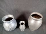 three vases sitting next to each other on a table