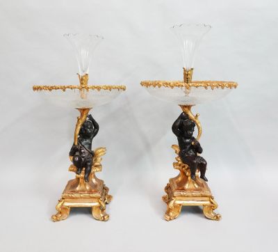 pair of antique bronze and glass candlesticks with a man and woman on a pedestal