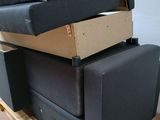 three black couches stacked on top of each other on a pallet