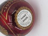 a red and gold ball with a sticker on it
