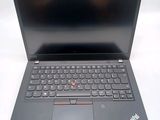 the laptop is open on a white surface with a black keyboard