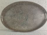 a silver tray with a floral design on it