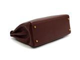 the large brown leather bag is open and ready to be used