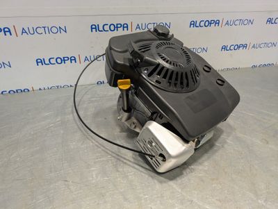 a close up of a small engine on a table in front of a wall