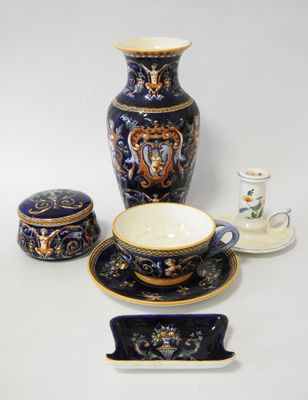 a blue and gold vase, a cup, saucer, and saucer