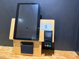 a tablet computer sitting on top of a wooden stand