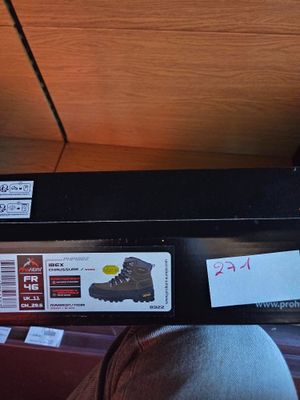 a black suitcase with stickers on it sitting on a bed