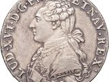 a silver coin with a portrait of a man in profile