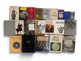 a lot of books that are stacked on top of each other