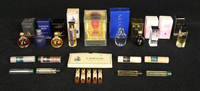 several bottles of perfume are lined up on a black surface