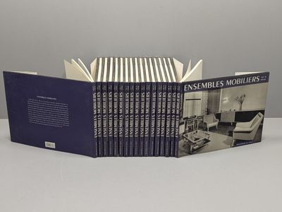 the book is open on a table with a few books on it