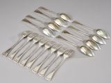 six silver spoons and six spoons on a white surface