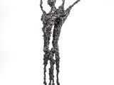 sculpture of a man and a woman holding hands in the air