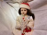 a doll that is sitting on a white sheet