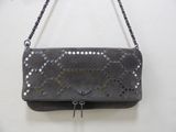 grey leather purse with metal studs hanging on a chain