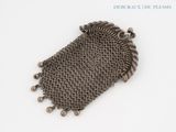 a close up of a chainmail purse on a white surface