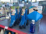 a display of blue and black cleaning tools on a shelf
