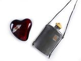 a red heart and a black flask on a white background