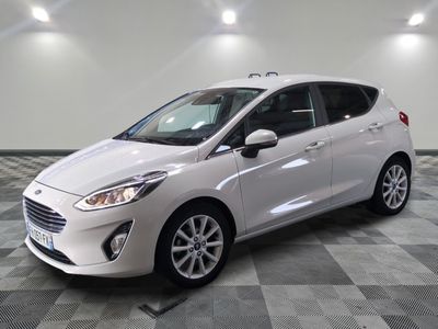 the white car is parked on a checkered floor in the garage