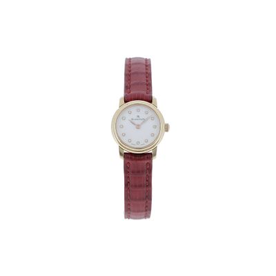 an image of a woman ' s wrist watch with a red strap