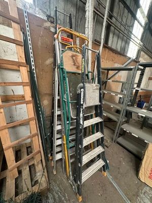 a ladder that is leaning against a wall in a warehouse