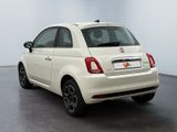 the back of a white fiat car parked in a white room