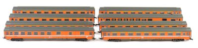 four toy trains are lined up on a white surface