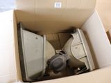 a box with a toilet and a toilet paper dispenser inside of it