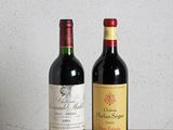 two bottles of wine sitting on top of a wooden table
