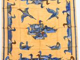 a yellow and blue scarf with birds and flowers on it