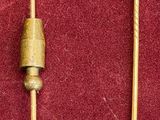pair of gold - plated earrings on a red velvet surface