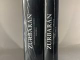 two black books sitting on top of a table next to each other