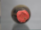 a close up of a red object on a glass table
