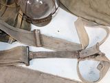 a pair of suspends and a lantern on a table
