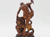 an old statue of a man holding a sword and a dog