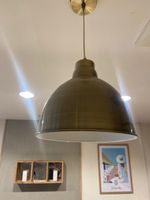TROIS SUSPENSIONS "cloche" en métal doré.