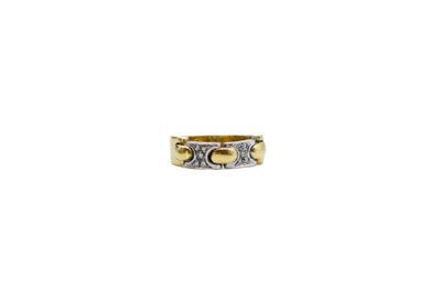 a close up of a gold and silver ring on a white background