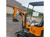 a close up of a small excavator parked in a lot