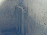 a dirty bathroom with a toilet and a shower stall