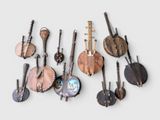 a lot of musical instruments that are hanging on the wall