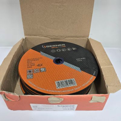 an orange and black disc in a cardboard box on a white surface
