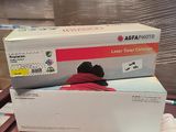 two toner cartridges are stacked on top of each other on a table