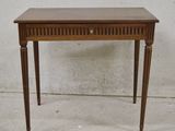 a small wooden table with a drawer on top of it