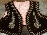 a painting of a vest on a wooden surface
