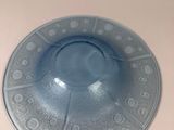 a blue plate with a pattern on it on a table