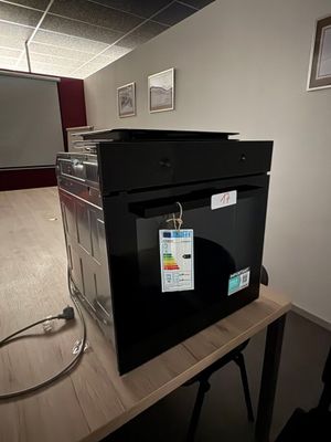 a microwave that is sitting on a table in a room